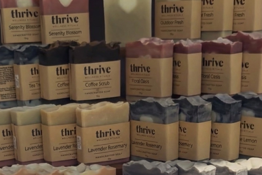 Handcrafted cold process soap bars from Thrive Wellness Rituals, showing natural textures and botanical colors.
